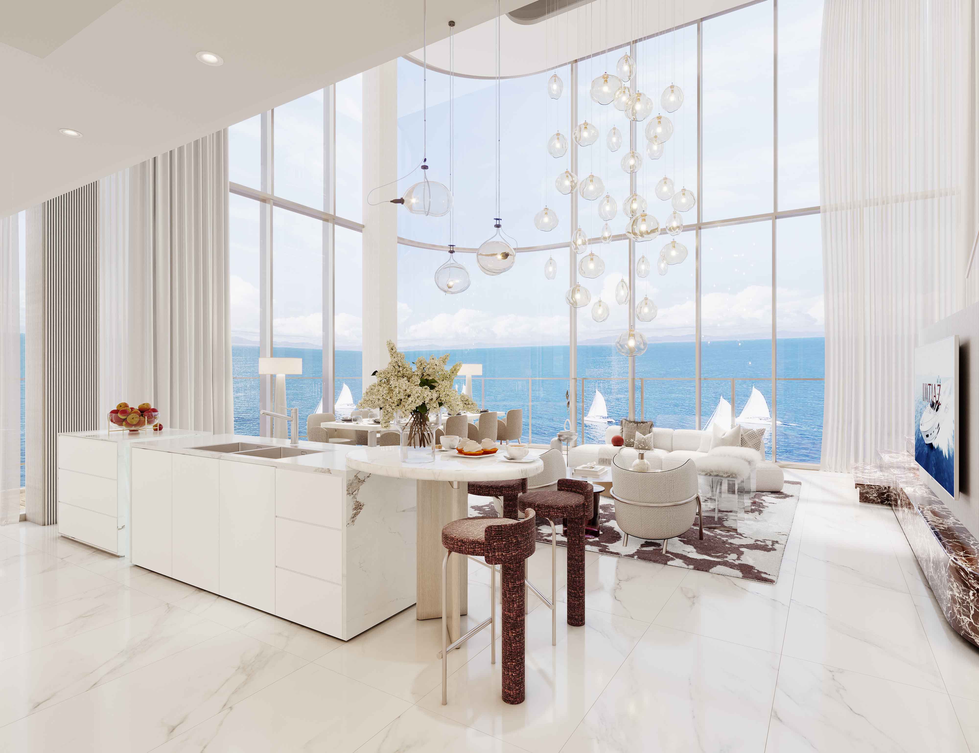 Cotier House 2 By Imtiaz Modern kitchen and living area with panoramic ocean view, elegant decor, and stylish lighting fixtures.
